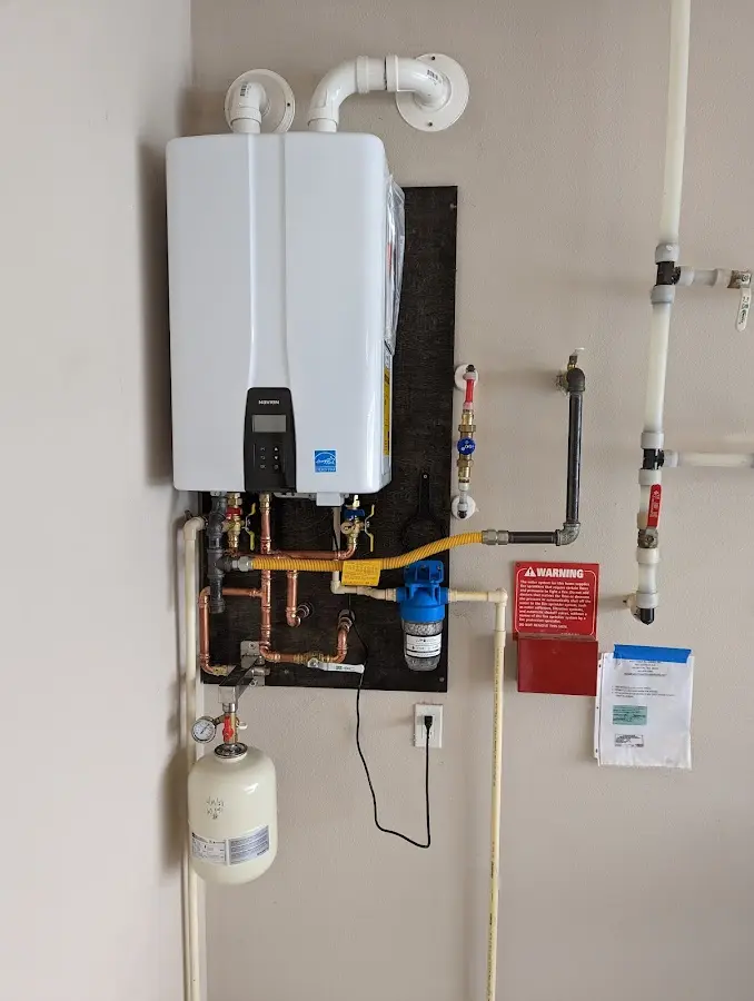 Professional plumber installing copper piping in a Baldwin home